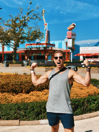 Smiling middle-aged American man holding his slimmer waistline, celebrating weight loss success.