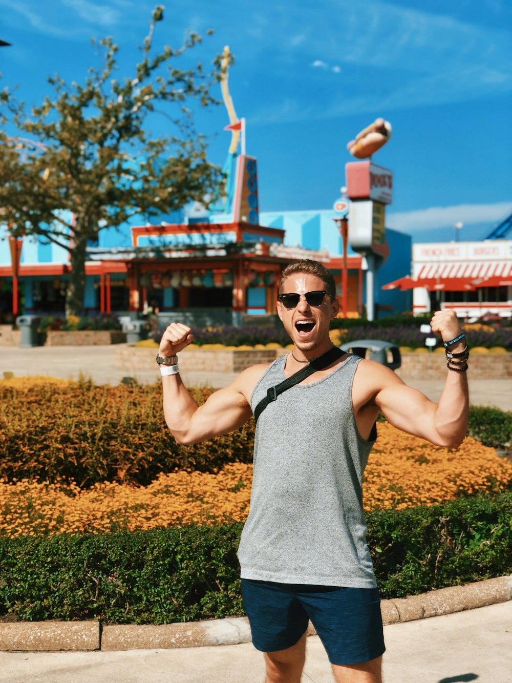 man wearing grey tank top and black sunglasses