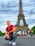 smiling man sitting by group of people near Eiffel tower