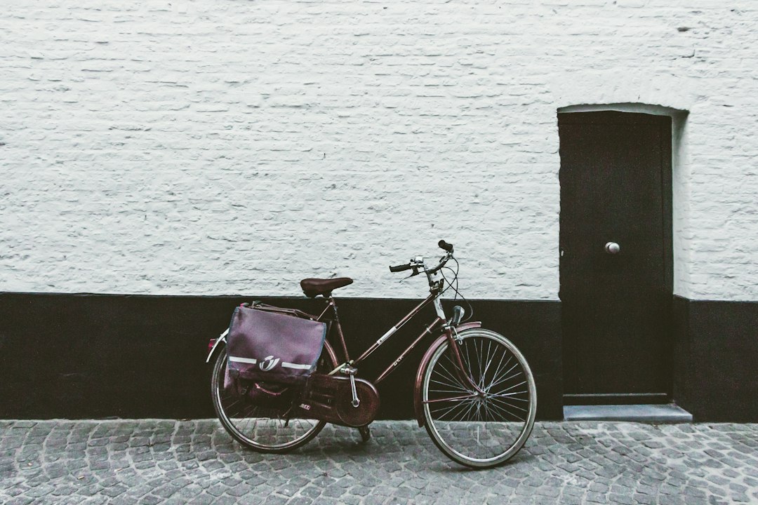 brown cruiser bike, Old bicycle in front of a white wall