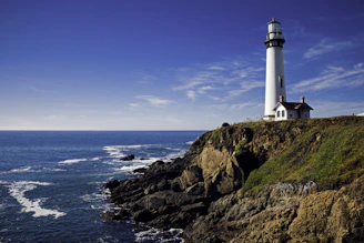 white lighthouse under cloudy sky