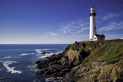 white lighthouse under cloudy sky