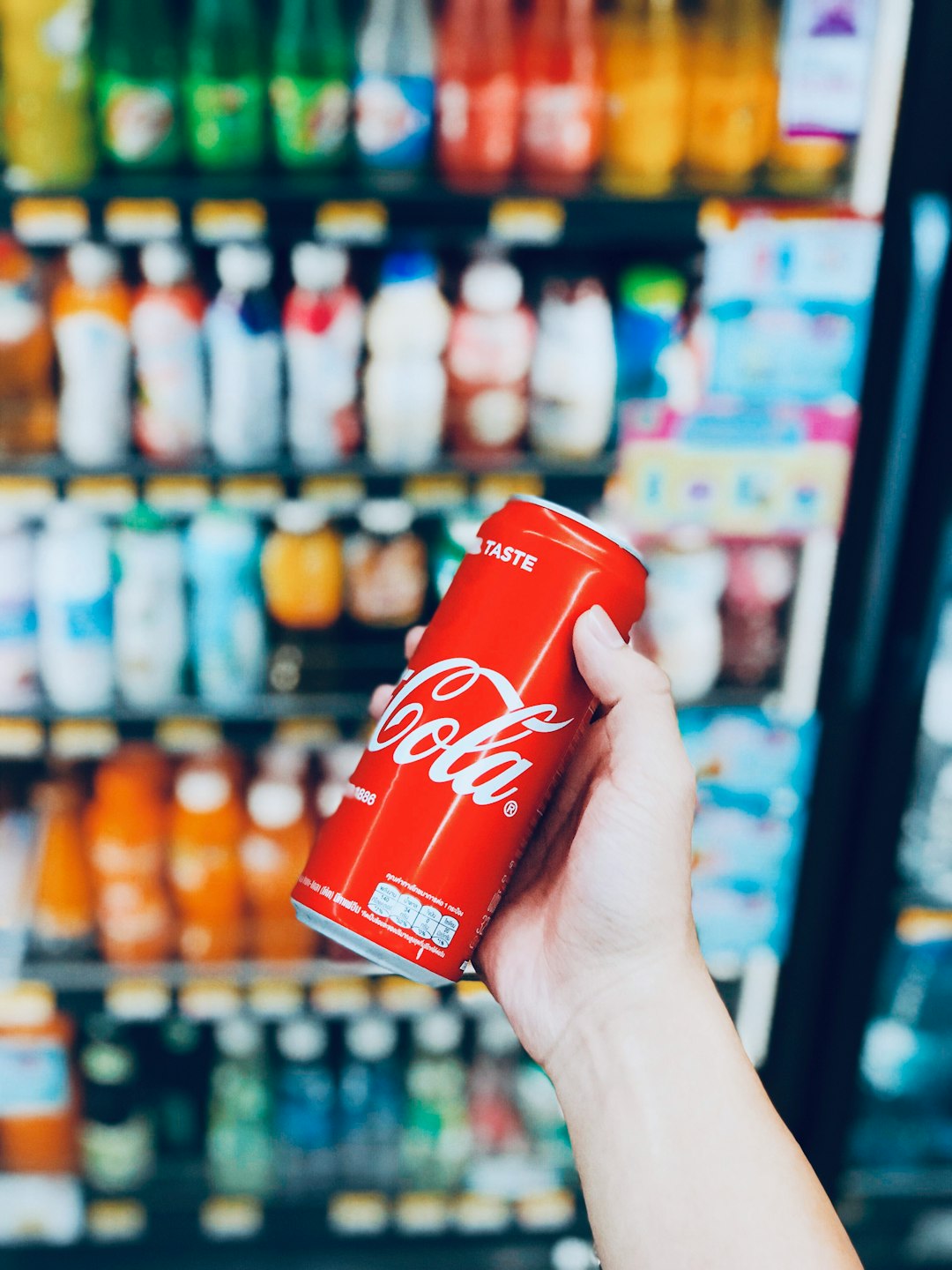 person holds Coca-Cola can