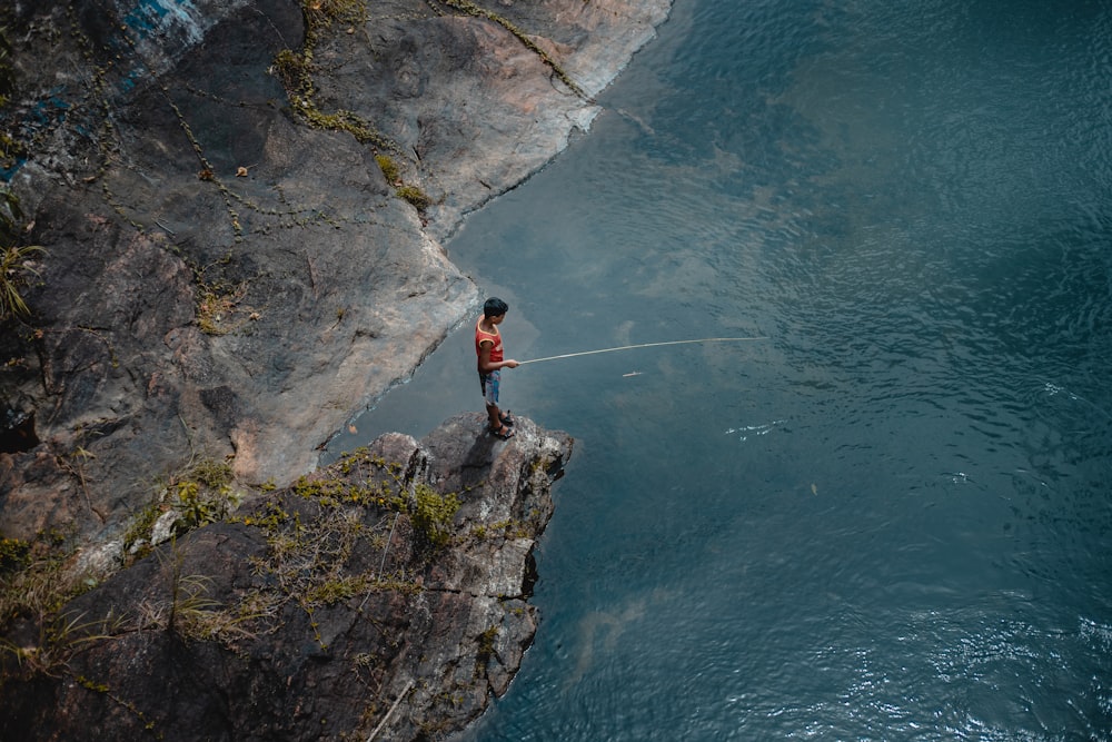 person fishes on water