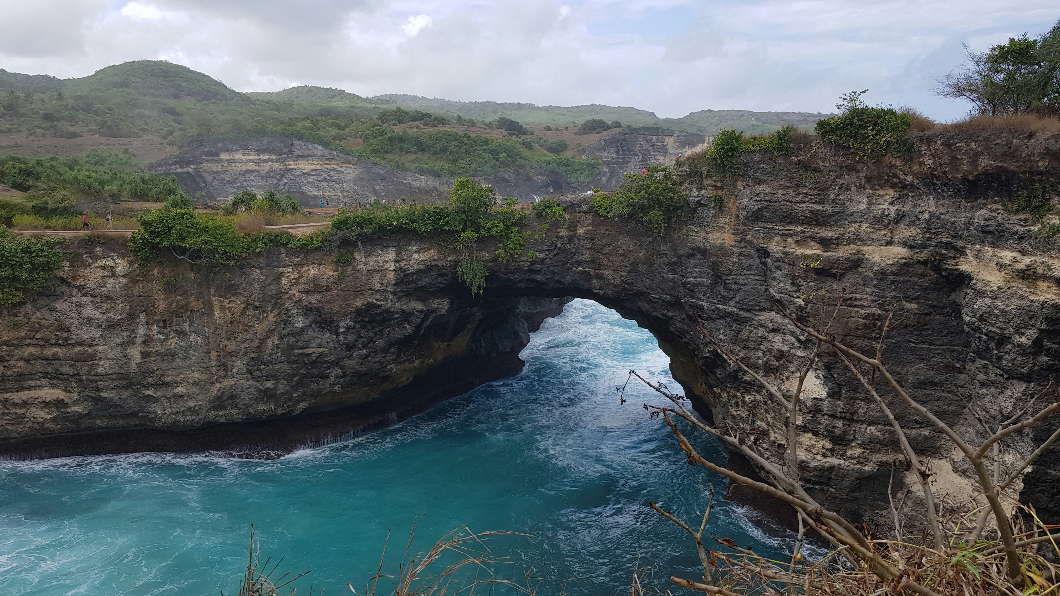 rocky mountain near body of water at daytime