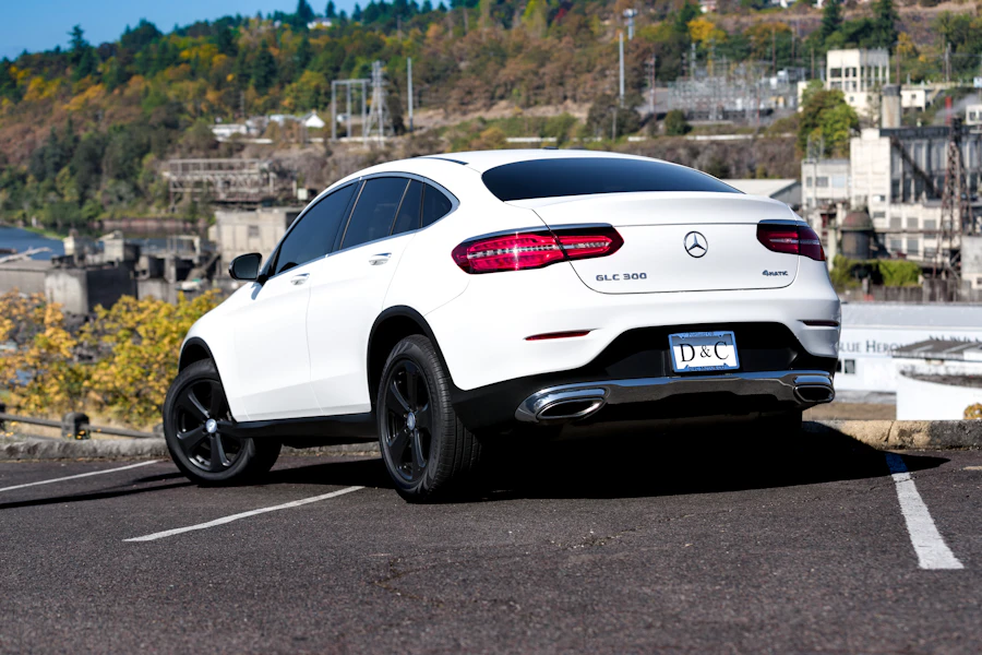 Bright white Mercedes-Benz on a roadside during daytime