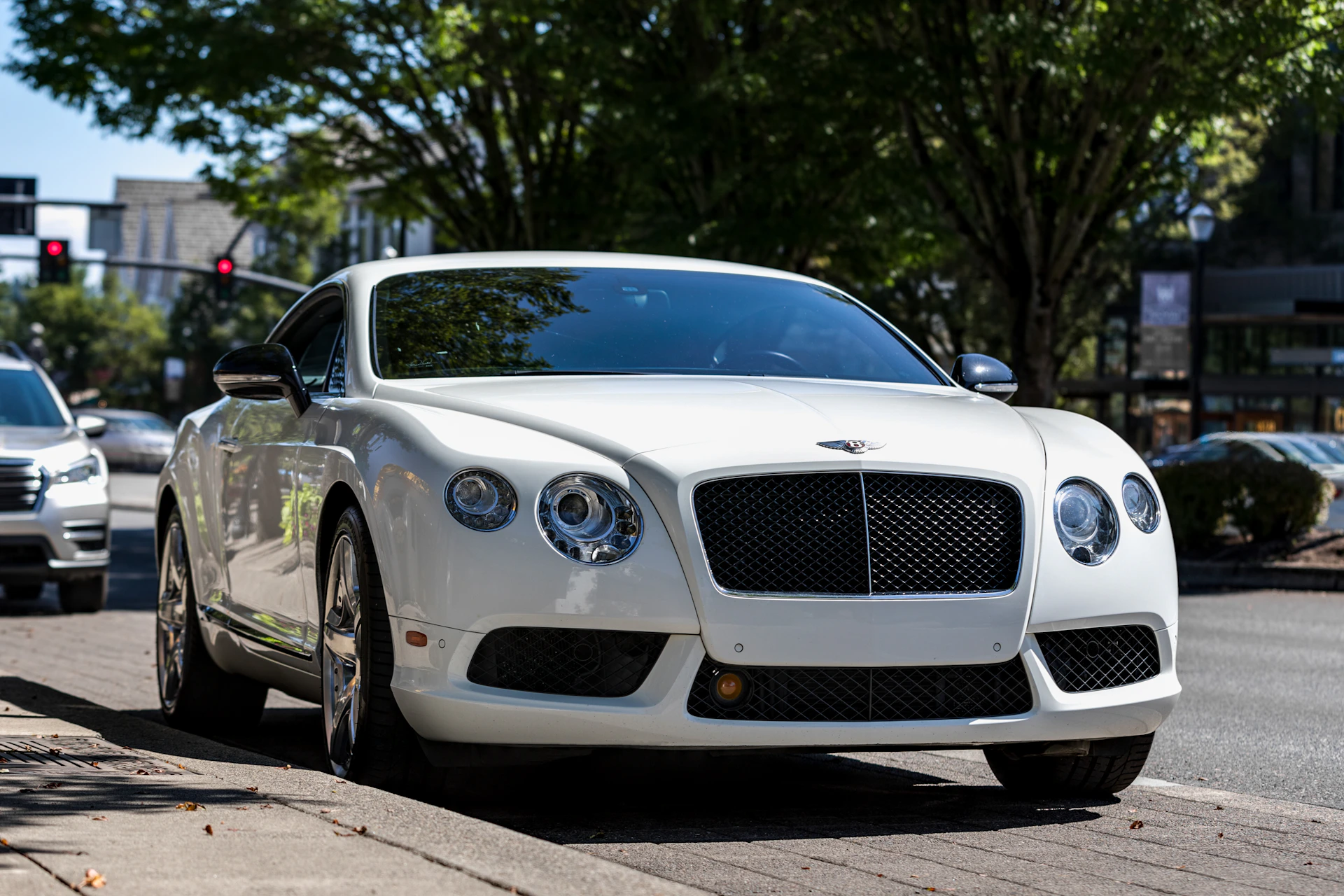 white coupe on road