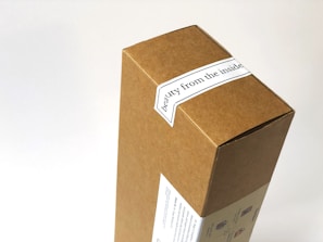 A cardboard box with a label that reads 'beauty from the inside'. The box features simple printed graphics on one side, over a white background.