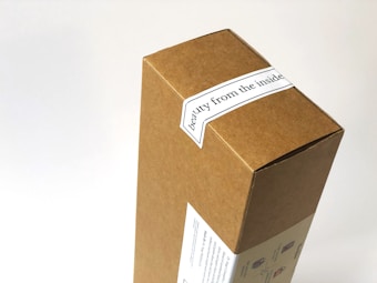 A cardboard box with a label that reads 'beauty from the inside'. The box features simple printed graphics on one side, over a white background.
