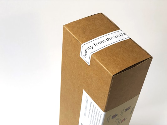 A cardboard box with a label that reads 'beauty from the inside'. The box features simple printed graphics on one side, over a white background.