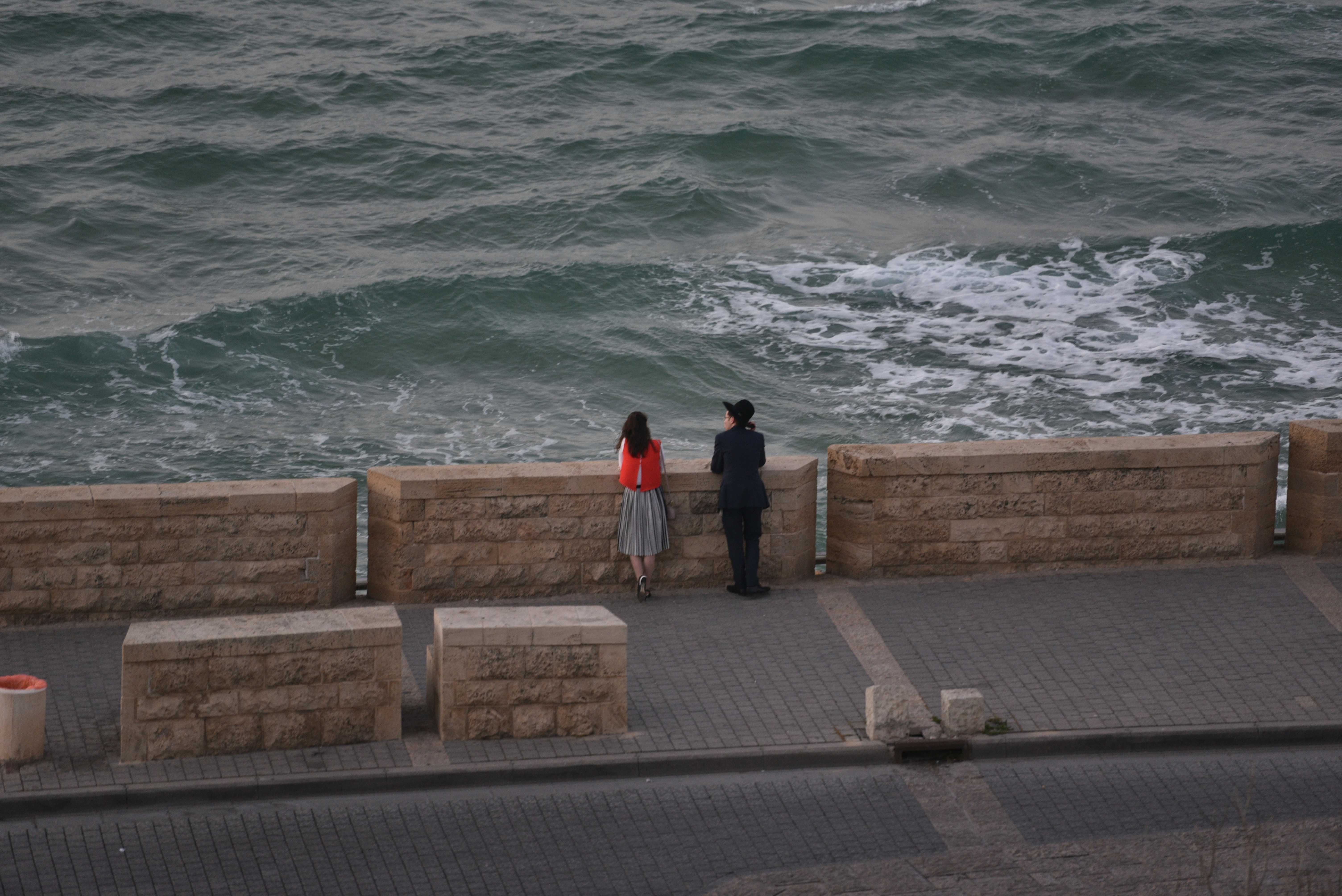 man and woman standing near sea