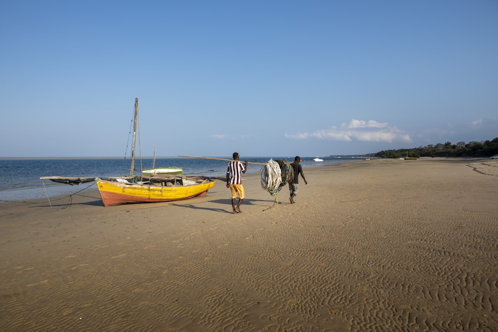 two man carrying net near boat