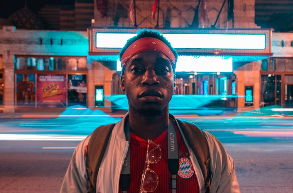 a man standing in front of a building at night