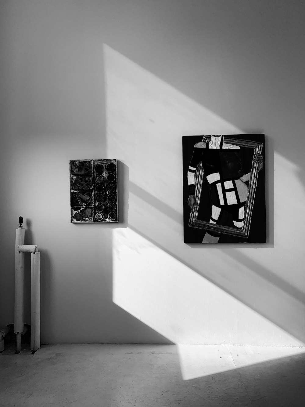 grayscale photo of paintings mounted on wall