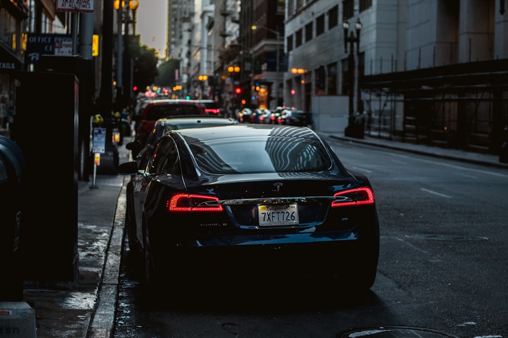 cars parked at the side of the road of the city during day