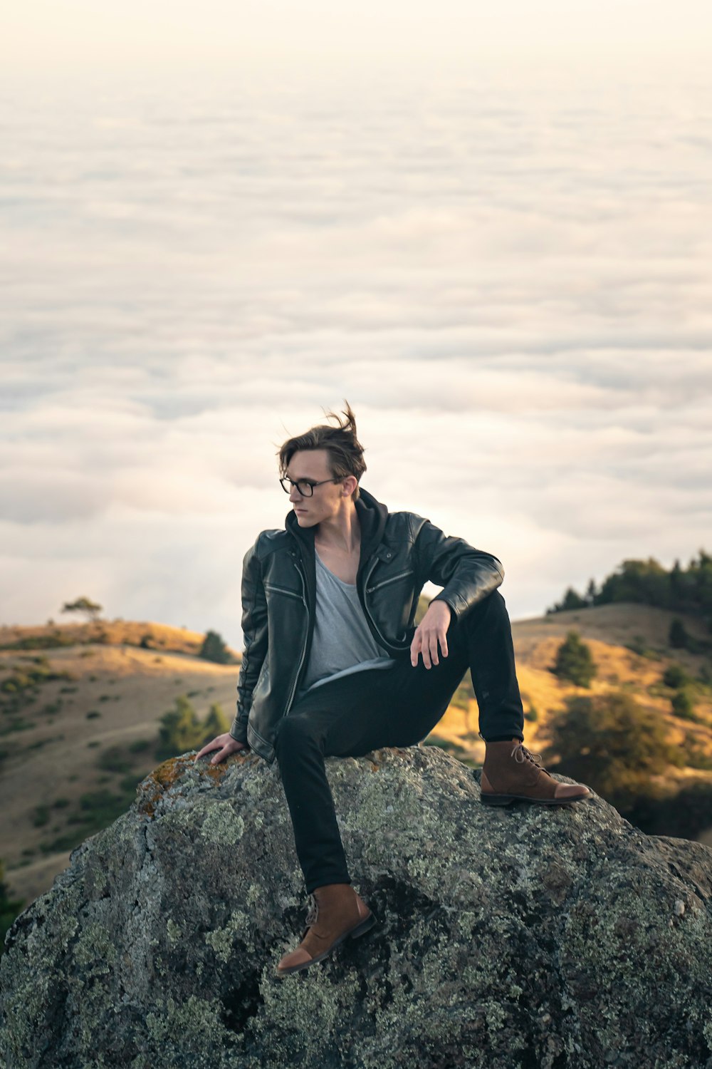 man sitting on rock