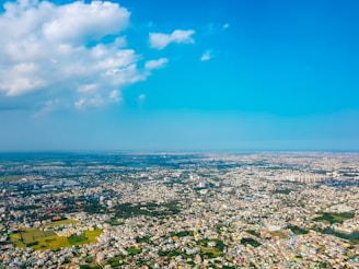 Aerial view of Huacho residential lots near commercial areas with clear skies.