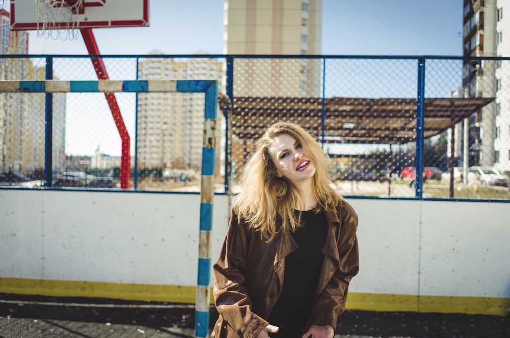 smiling woman wearing brown jacket