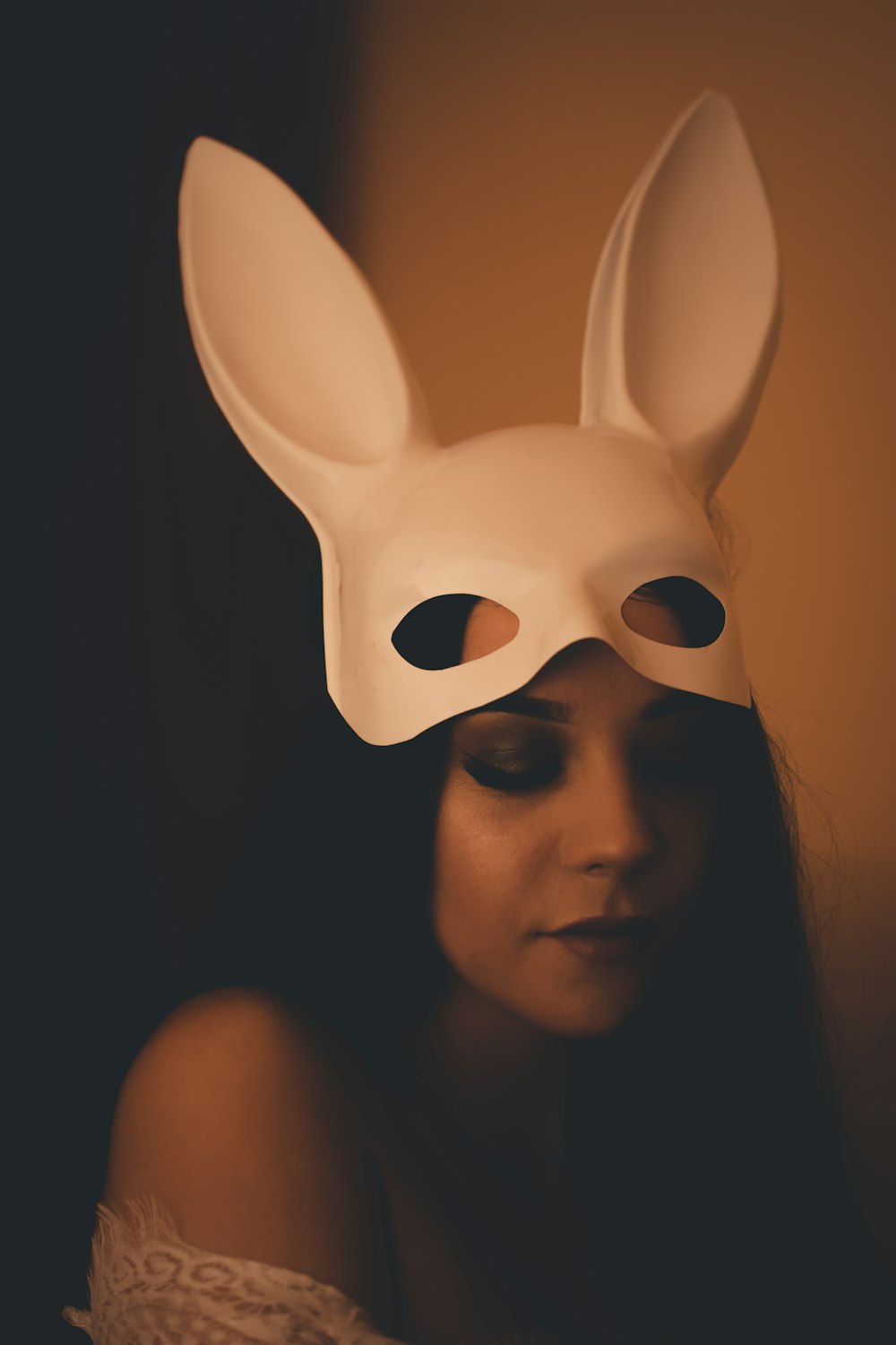 woman wearing white bunny mask