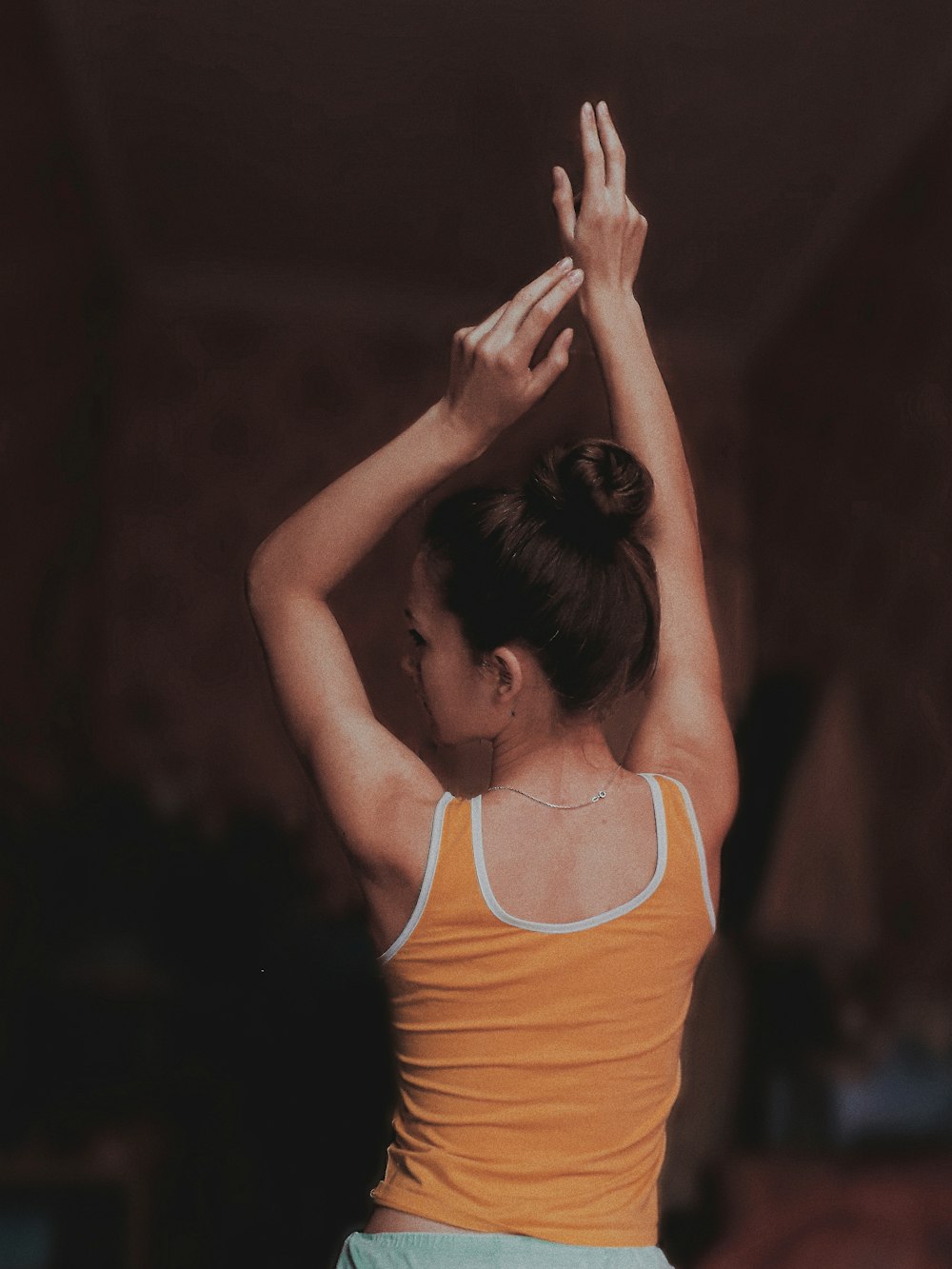 woman raising both hands