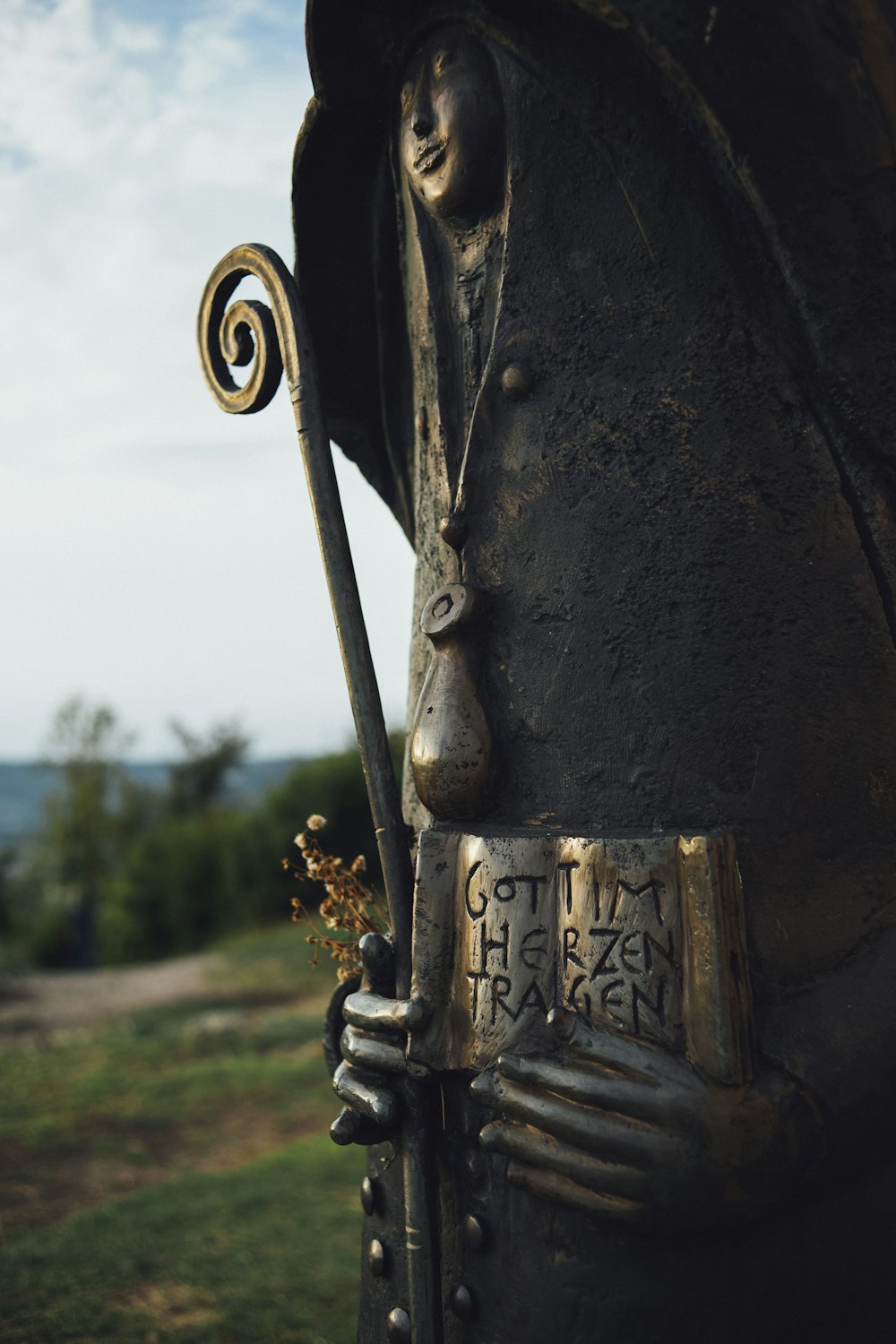 a statue of a man with a hat and cane