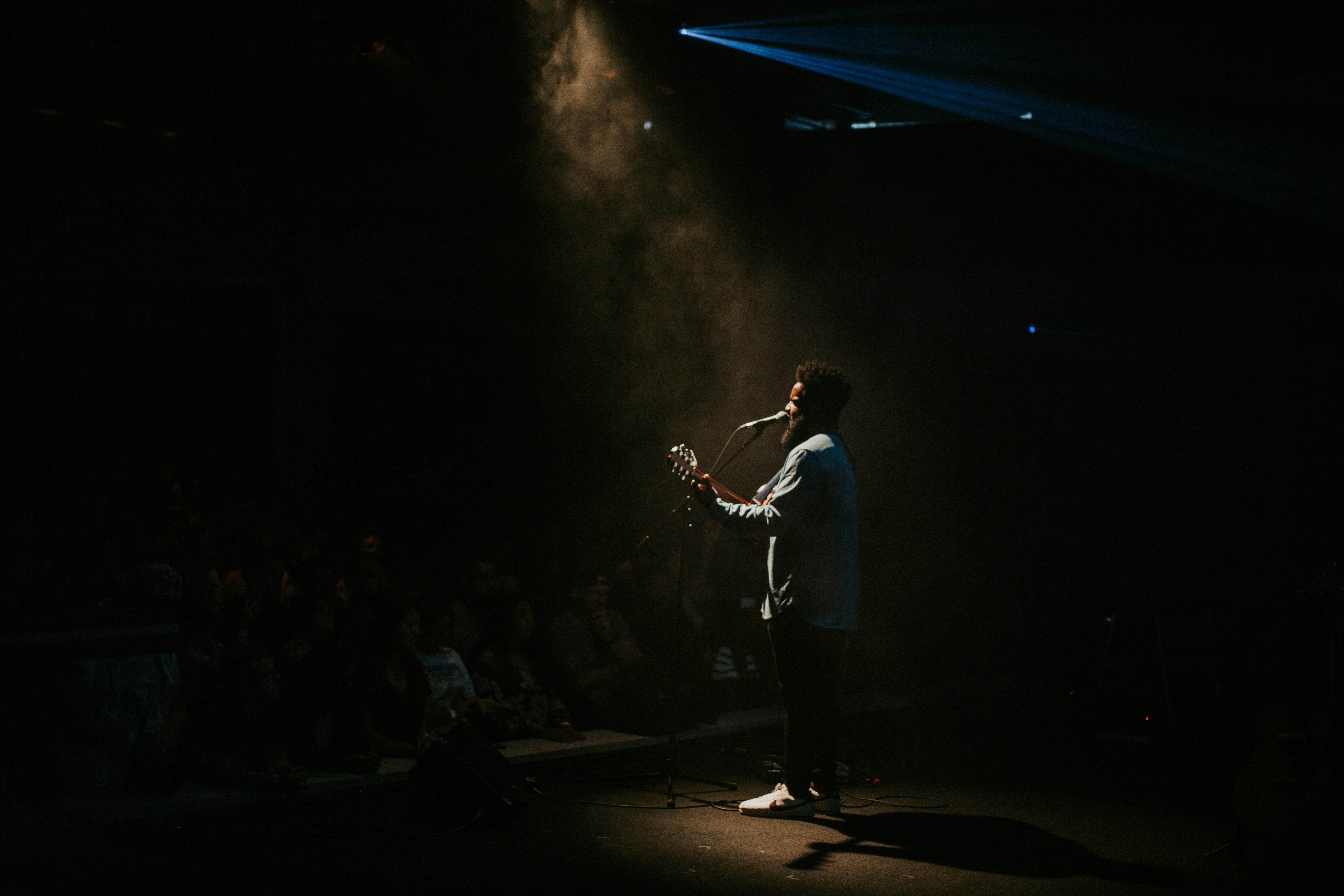 a man standing on a stage holding a microphone