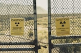 a couple of signs that are on a fence