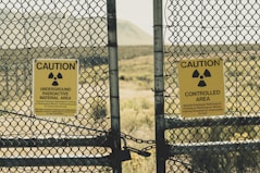 a couple of signs that are on a fence