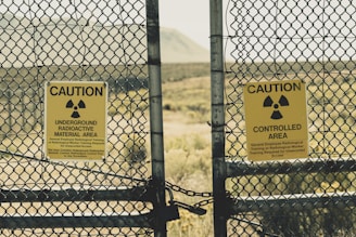 a couple of signs that are on a fence