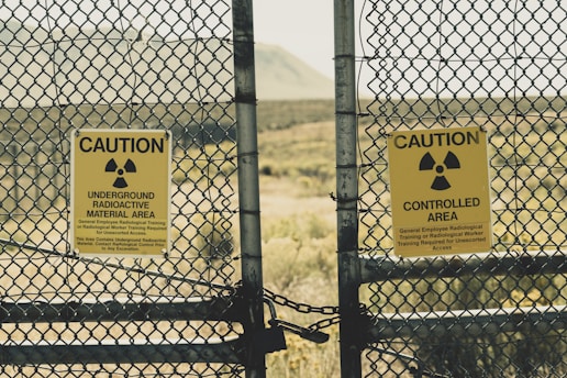 a couple of signs that are on a fence