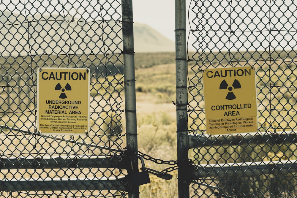 a couple of signs that are on a fence