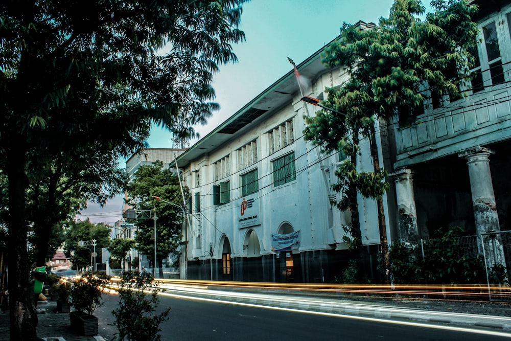 a long exposure shot of a street with a building in the background