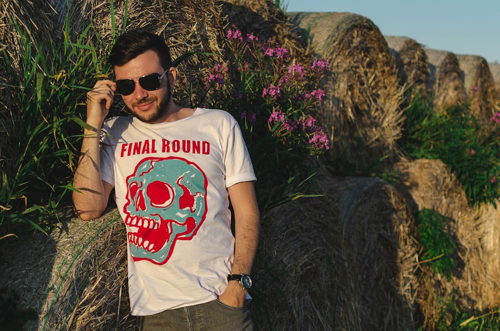 man leaning on hay