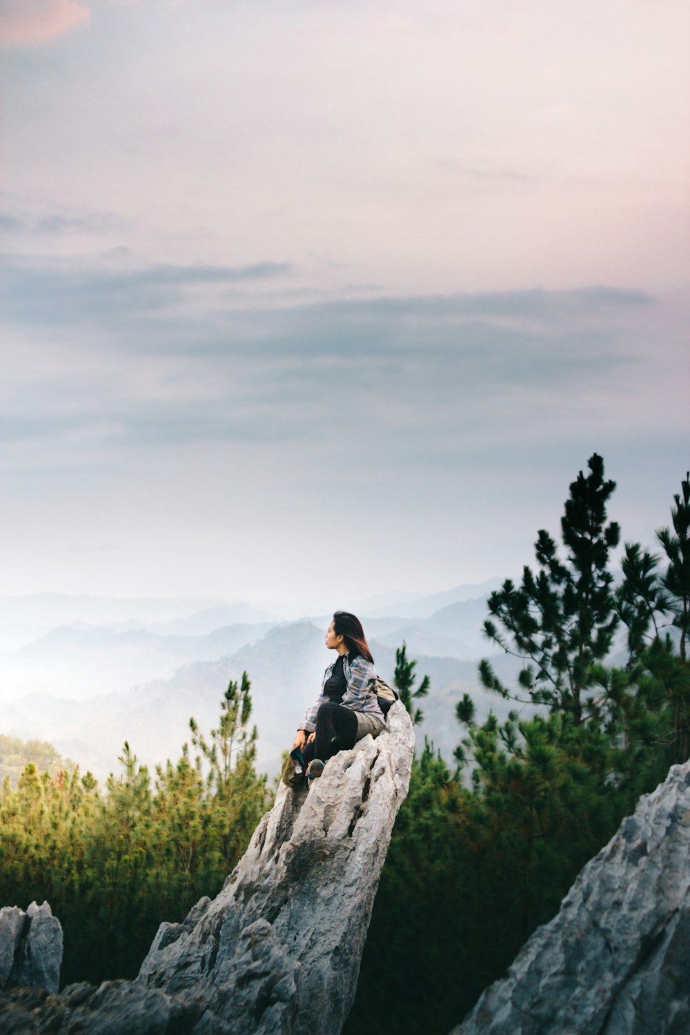 woman sitting on rock