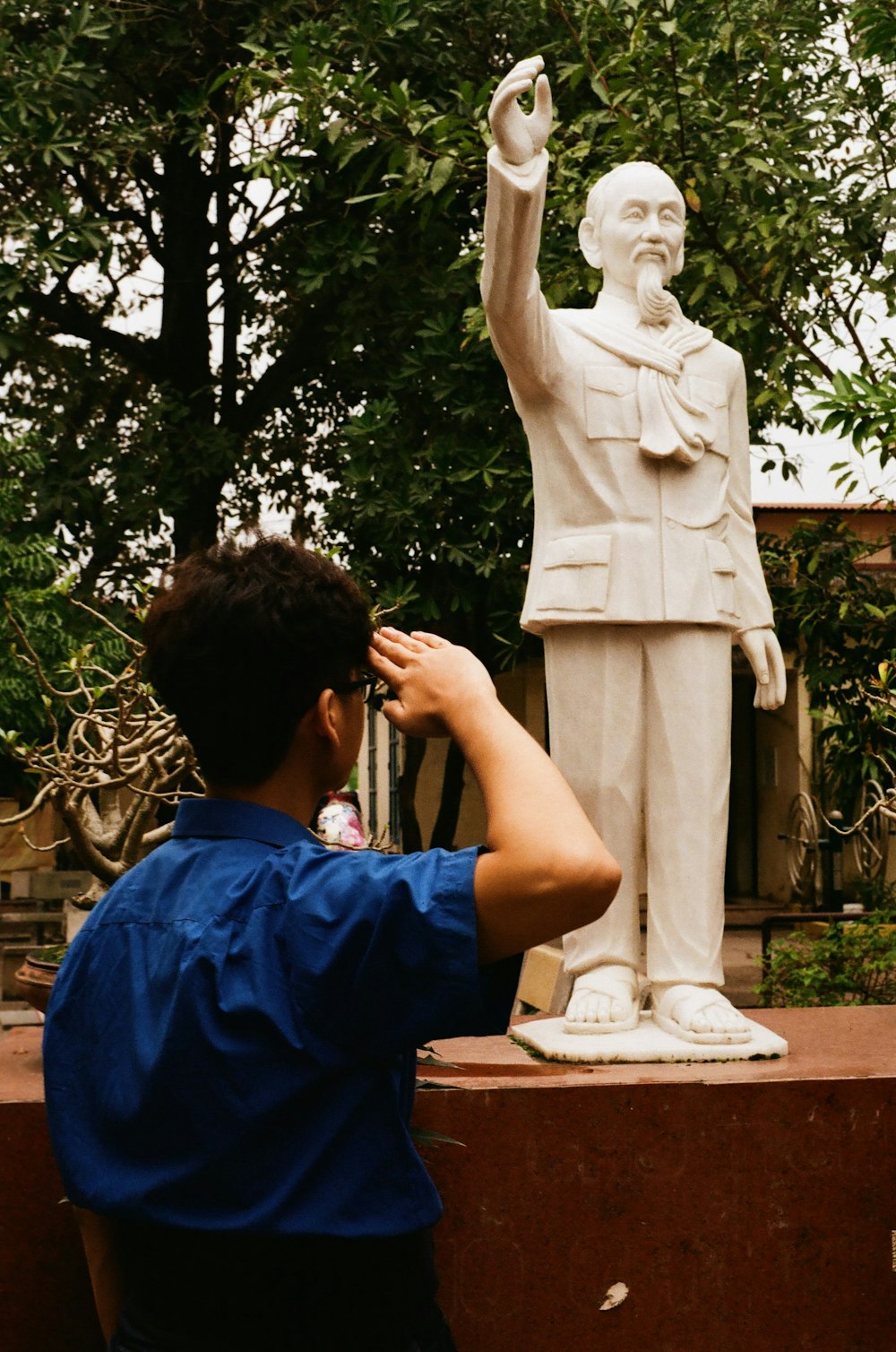 man saluting on male statue