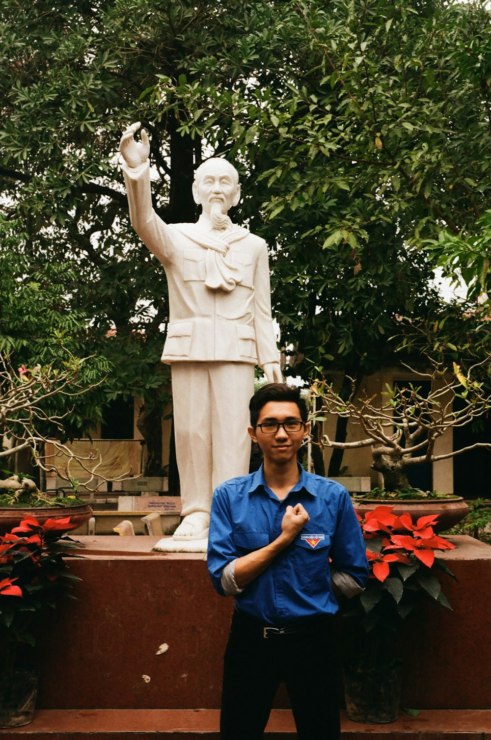 man standing in front of statue