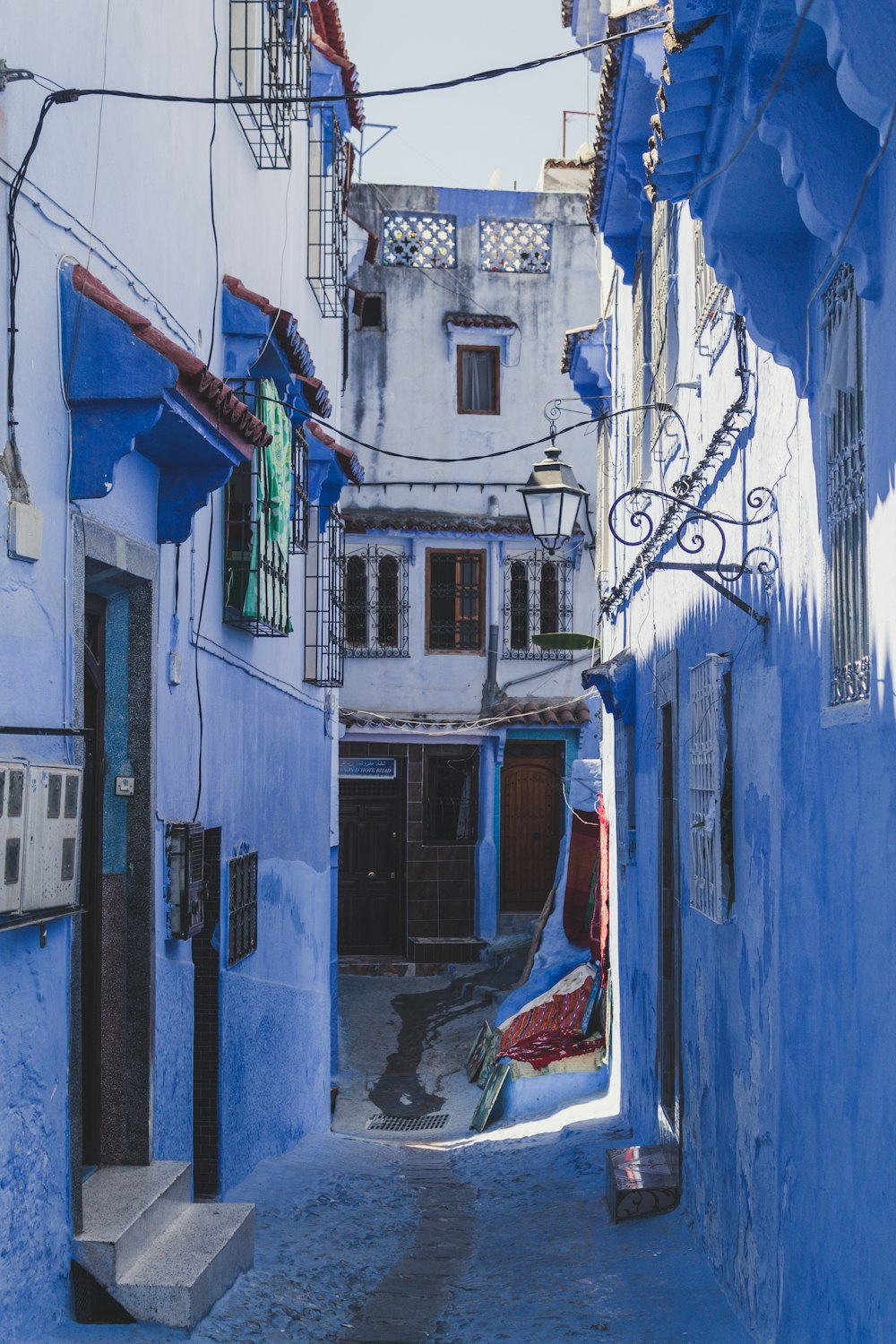 blue painted buildings alley during day