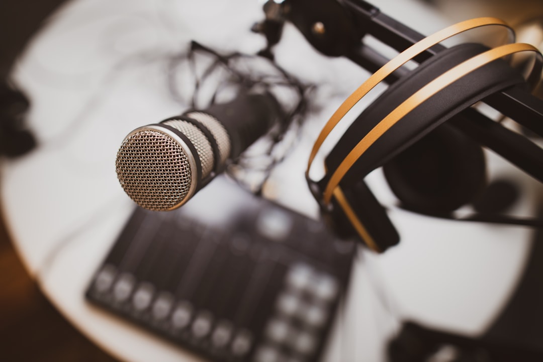 Podcasting setup with headphones, desk and professional microphone