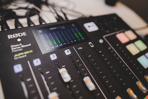 An audio mixing console with various controls.