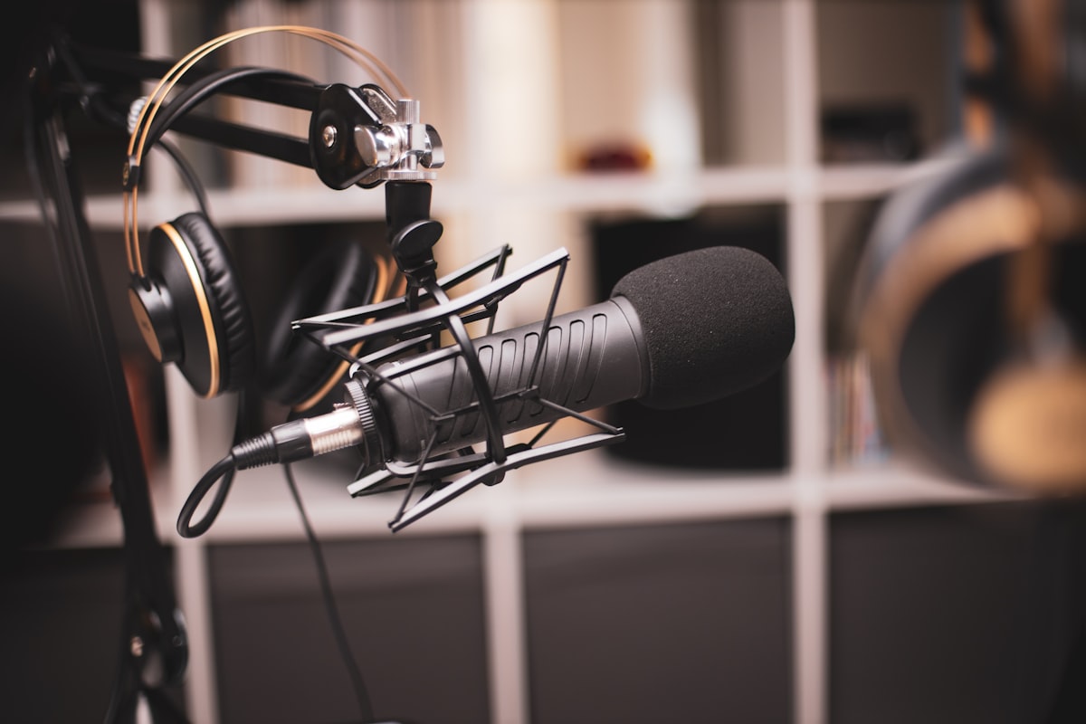 Podcast Mic on stand with headphones resting on the stand.