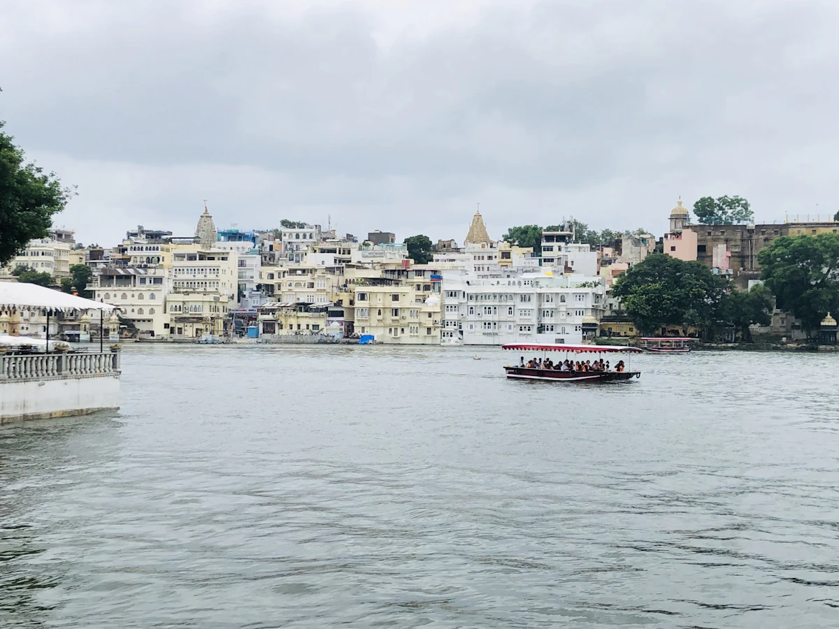 A passenger boat on Lake Pichola near lakeside houses