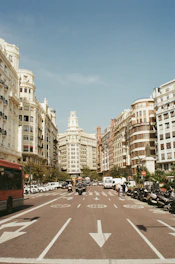 red bus surrounded by buildings