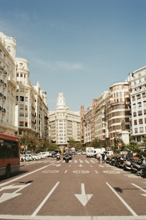 red bus surrounded by buildings