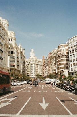 red bus surrounded by buildings