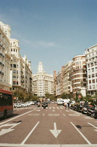 red bus surrounded by buildings