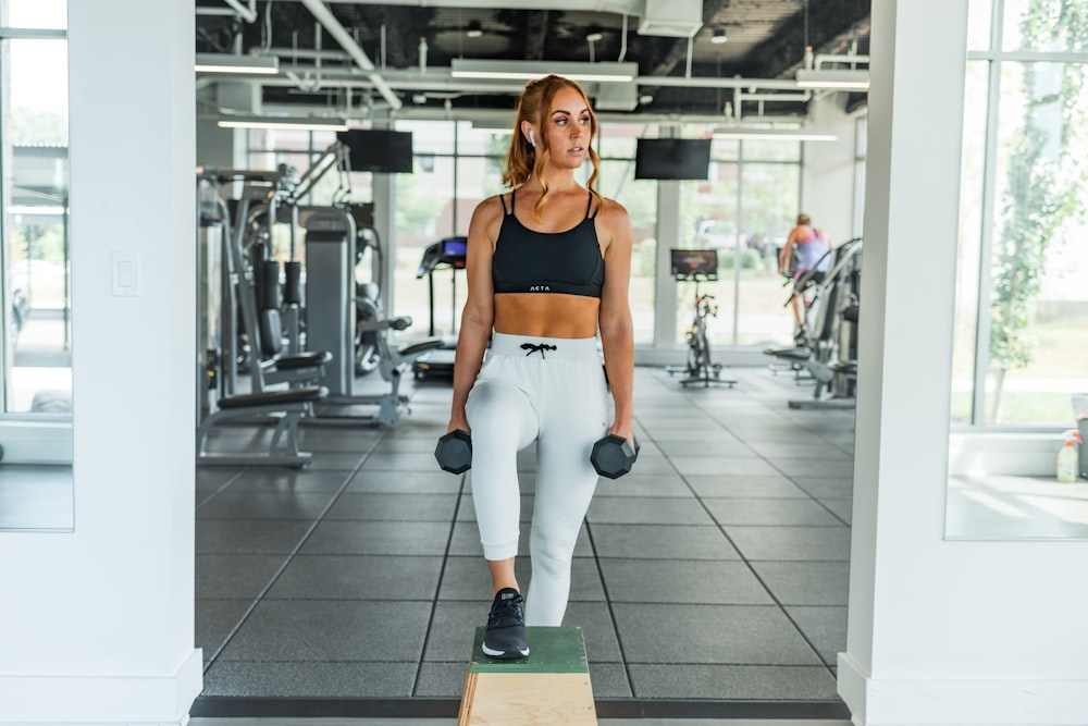 woman carries dumbbells