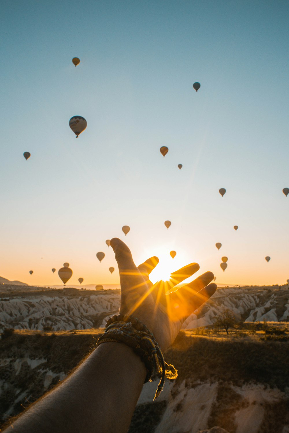 left human hand with air balloons background