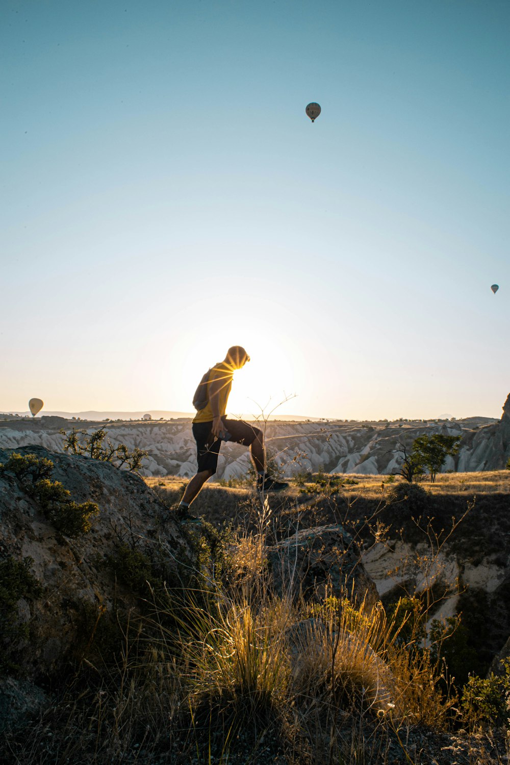 person in black shorts on mountain during daytime