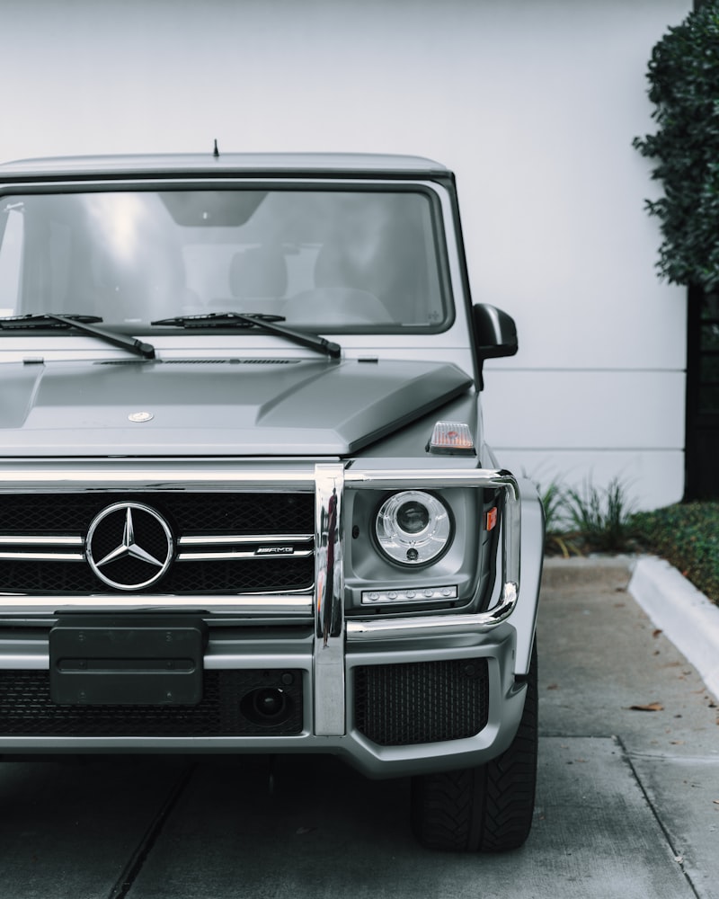 Silver executive vehicle parked in daylight