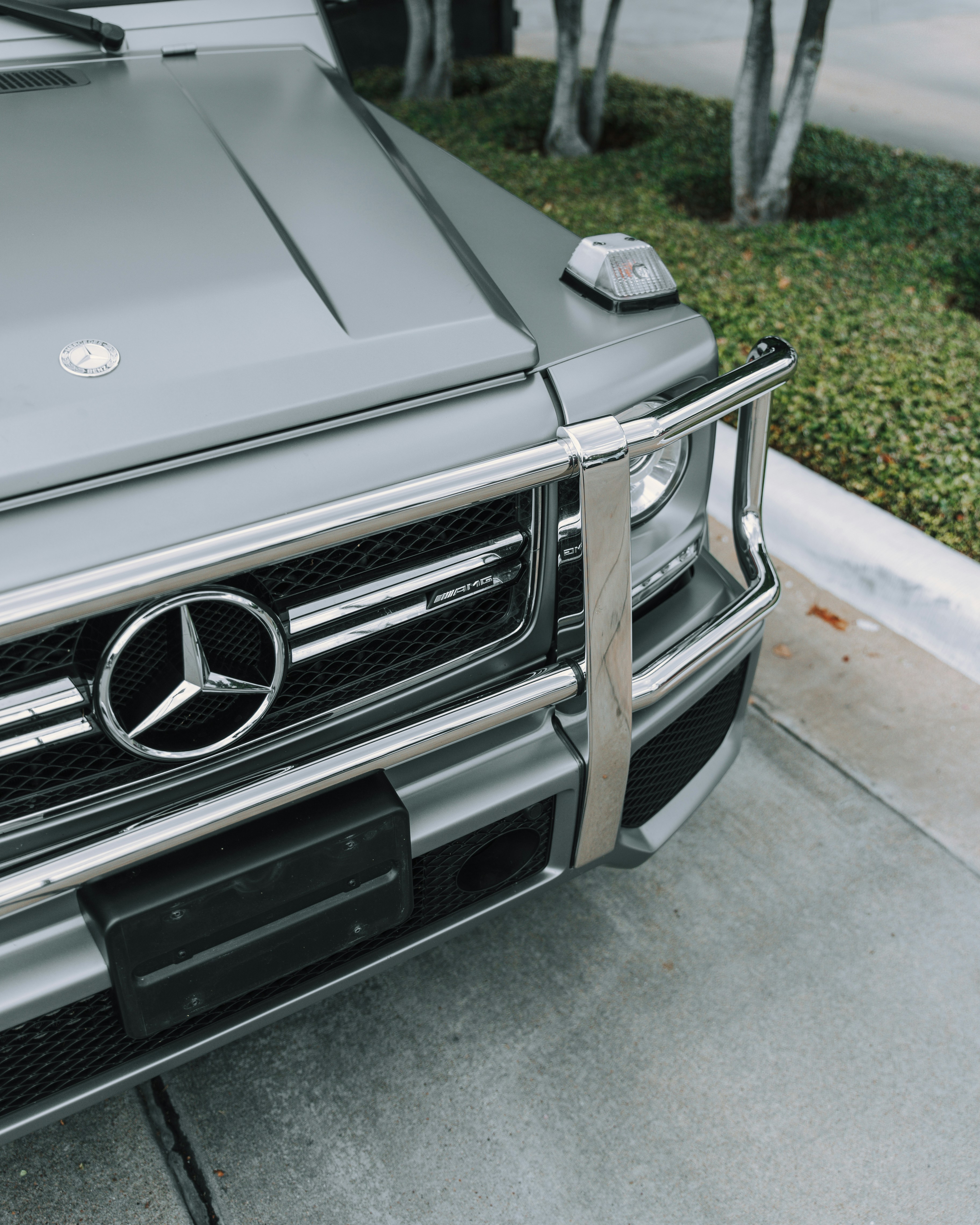 black Mercedes-Benz SUV parked near tree